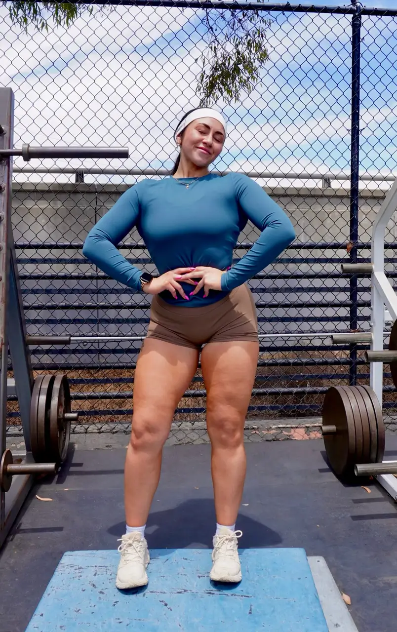 Coach Marissa posing outside at a fitness gym